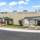A modern recreation center named Cedar Park Recreation, with a stone facade, metal awnings, and landscaped entrance drive.